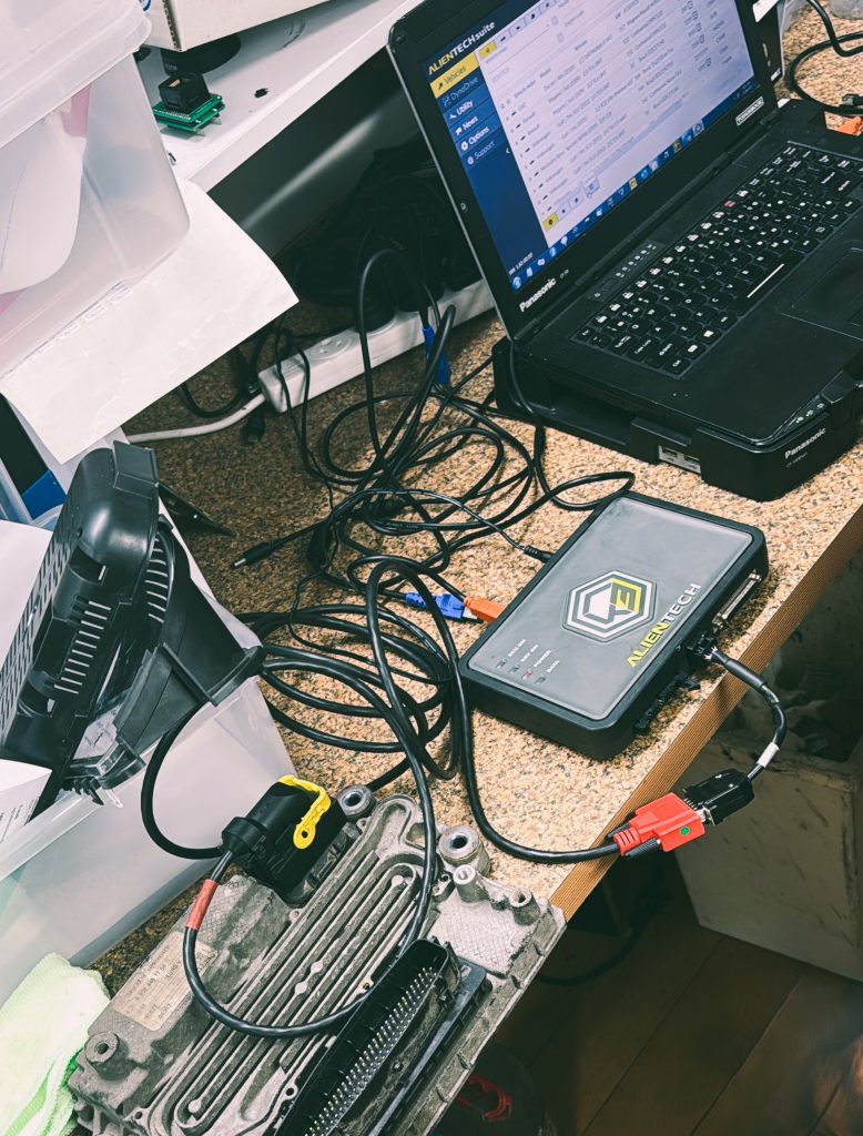 ECU flashing process on workbench during software tuning - Euro Car Electronics - eurocarelectronics.com.au